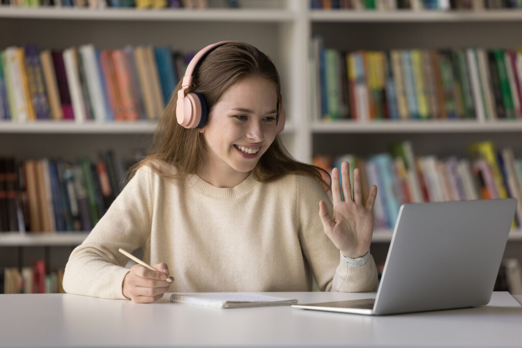 Happy student girl in headphones